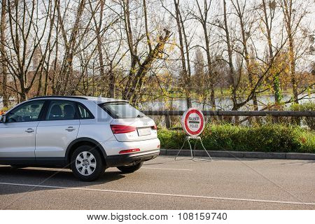 STRASBOURG FRANCE - NOV 14 2015: French Police checking vehicles on the 'Bridge of Europe' between Strasbourg and Kehl Germany as a security measure in the wake of attacks in Paris - slow down police sign
