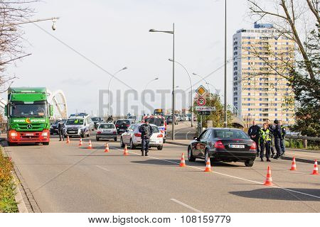 STRASBOURG FRANCE - NOV 14 2015: French Police with machine gun checking vehicles on the 'Bridge of Europe' between Strasbourg and Kehl Germany as a security measure in the wake of attacks in Paris