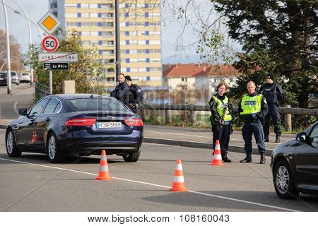 STRASBOURG FRANCE - NOV 14 2015: French Police with machine gun checking vehicles on the 'Bridge of Europe' between Strasbourg and Kehl Germany as a security measure in the wake of attacks in Paris