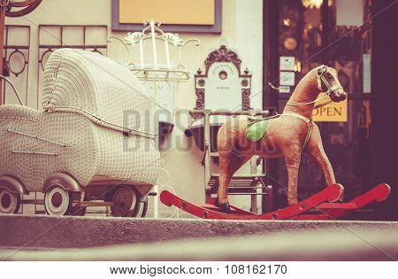 Retro baby carriage and toy rocking-horse antique sale