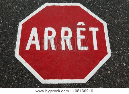 french Quebec stop sign painted on asphalt