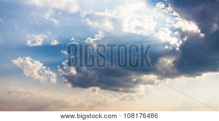 Beautiful blue sky with sunbeams and clouds