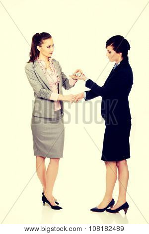 Caucasian businesswoman giving a plane to her partner.