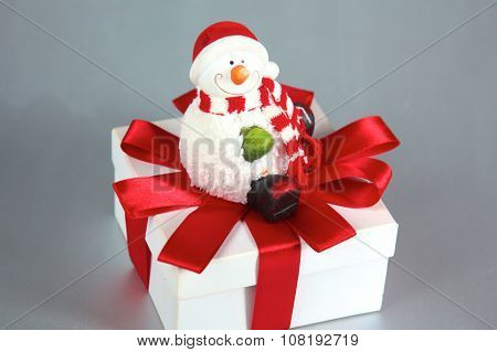 New Year gift on a golden tinsel background boly