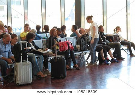 Travellers With Their Luggage At The Airport