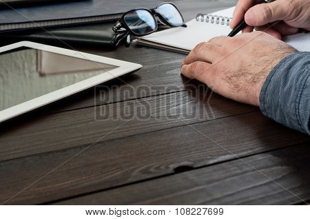 Male Hands Writing In A Notebook On The Office Table