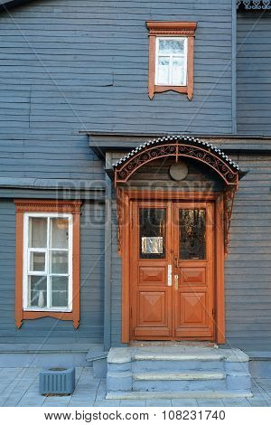 Stellblue Wooden Facade With Brown Door And Windows