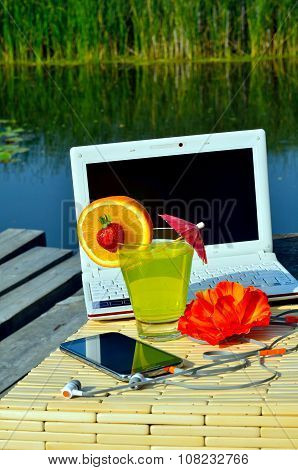 Cocktai With Fruits, Laptop, Cell Phone, Headphones And Bath Towels