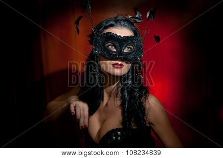 Portrait of attractive sensual young woman with mask, indoors. Sensual brunette lady posing