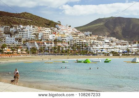 Sandy Beach With Blue Parasols And Sunbeds, Los Cristianos, Tenerife, Spain