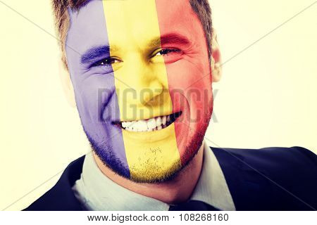 Happy man with Andora flag painted on face.