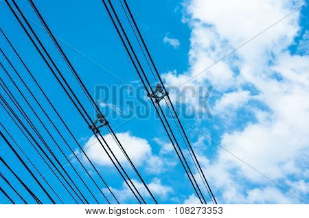 High Voltage Transmission Lines On Blue Sky
