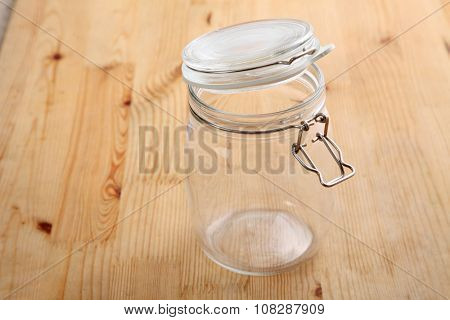 opened air tight glass jar on the wooden background