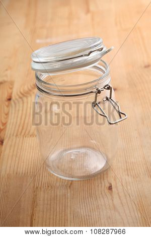 opened air tight glass jar on the wooden background