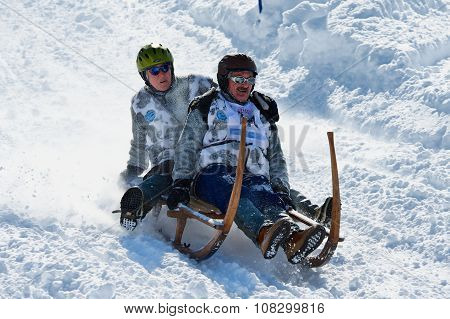 People ride traditional horn-sledge at 12-th annual Horn-Sledge Race in Grindelwald.