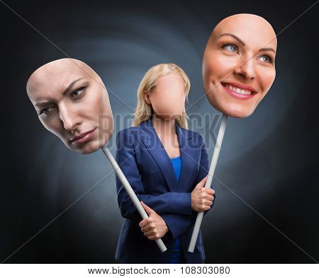 Businesswoman choosing face over grey background