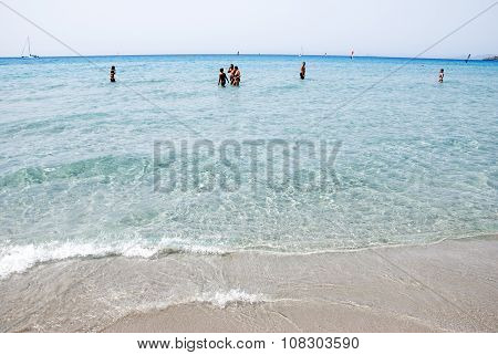 Porto Pino, Italy-august 06: Unidentified People Walking In The Sea In Summer Time On August 06.2012