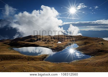 Mountain Lake. Sunny day with blue sky. Beautiful sun rays. Lake Koruldi. Caucasus, Georgia, Zemo Svaneti