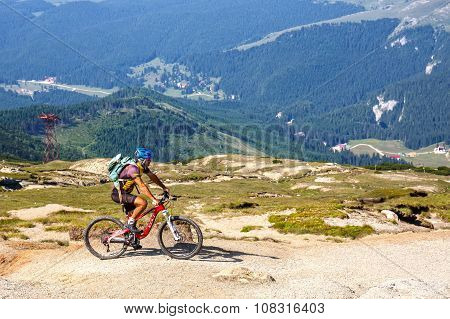 Bucegi Mountains, Romania July 09, 2015: Unidentified Biker Climbs The Hill In Bucegi Mountains In R