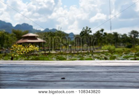 Wood Floor With Pond And Garden Background