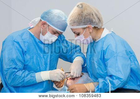 Dentists during surgery for implant placement