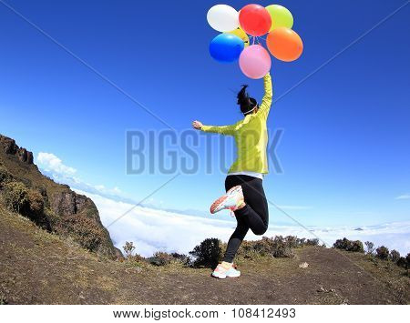 young woman with colorful balloons