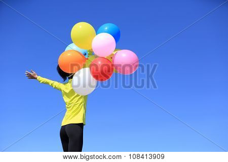 young woman with colorful balloons