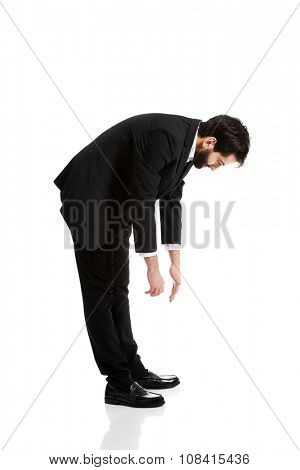 Young handsome businessman bending down.