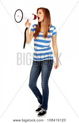 Teenage woman screaming through megaphone.