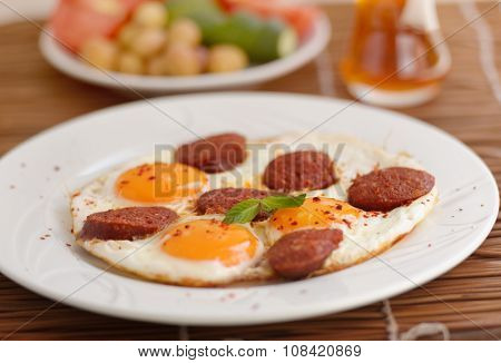 Fried eggs with sucuk on a plate