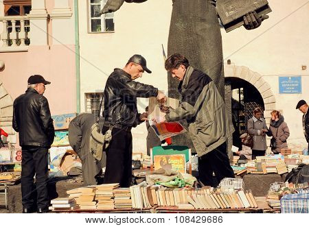 People Buying Vynil Records And Vintage Books On The Flea Market