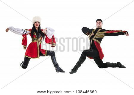 young couple wearing a folk costume dancing against isolated white with copyspace