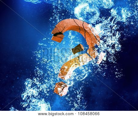 Question mark sink in clear blue water