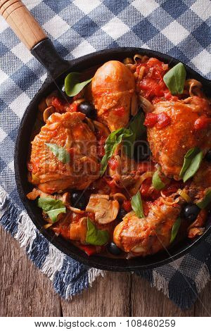 Cacciatori Chicken With Black Olives Close-up In A Pan. Vertical Top View