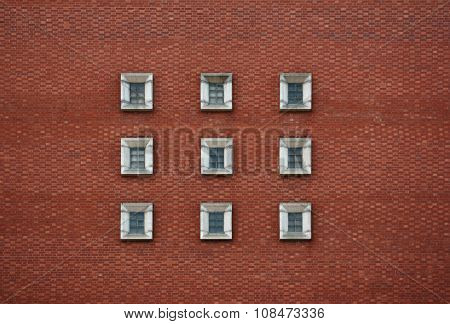 9 concrete windows square and a red brick wall
