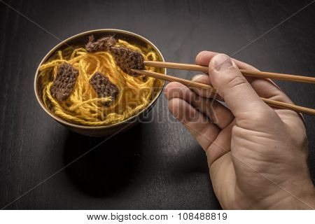 Food Knitted From Woolen Thread Lies On A Plate, As A Chinese Dish Of Noodles And Meat, The Human Ha