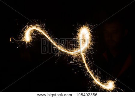 sparkler light trail in dark environment using slow shutter speed