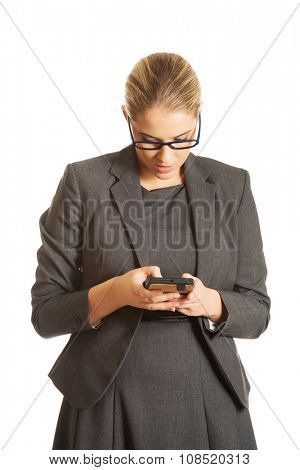 Beautiful businesswoman sending a message
