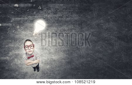 Wideangle picture of funny schoolboy with paper plane in hand