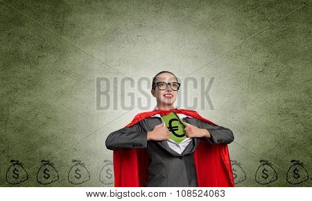 Young woman acting like super hero with euro sign on chest