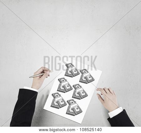 Businessman hands drawing money making formula in notepad