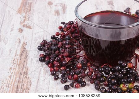 Bunch Of Fresh Elderberry With Juice On Old Wooden Background, Healthy Nutrition