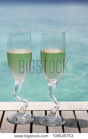 Two Champagne Glasses By The Ocean