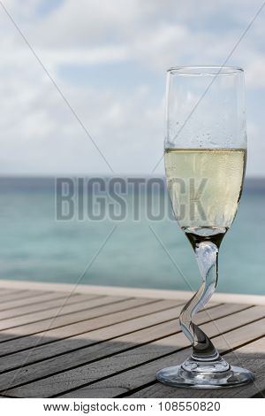A Champagne Glass By The Ocean