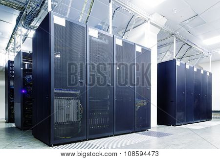 room with rows of server hardware in the data center