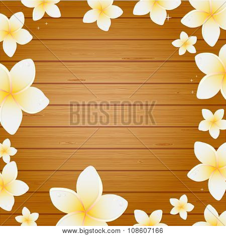Spa background with frangipani flowers on wooden planks background. Background for web, spa, beauty salon an health center.