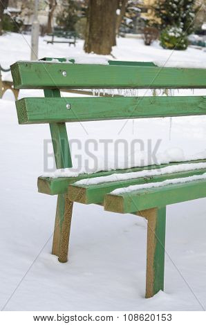 Snow Covered Bench In A Park
