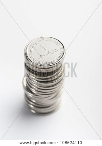 Heap of UAE one dirham coins. Over the shoulder view.