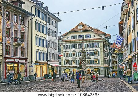 LUCERNE SWITZERLAND - JANUARY 04 2015: Muhlenplatz in Lucerne Old Town with cobbled streets and historical buildings with frescos. This area served as a venue for trade fairs since the 16th century