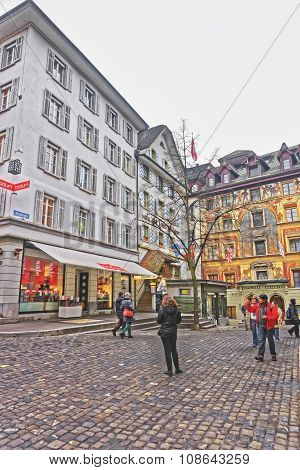 LUCERNE SWITZERLAND - JANUARY 04 2015: Tourists see the sights of the swiss city of Lucerne. Nestling in the foothills of the Alps it attracts several million visitors annually